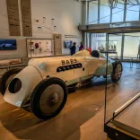 An old motor car on display in a land speed museum.