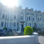 A hotel bathed in glorious sunshine on the seafront.