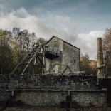 A winding wheel and chimney in a lead mine attraction.
