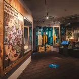 Display board of an historical map and cabinet of artefacts in a museum.