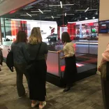Group on a tour with a guide at a broadcasting studio.