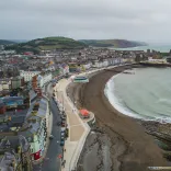 A coastline and town taken from the top of a cliff.