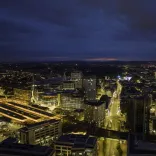 Aerial shot of a city all lit up at night.