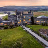 Aerial shot of a stately castle accommodation at twilight.