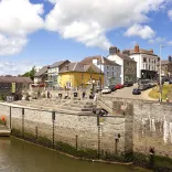 A river with colourful buildings above