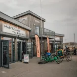 A bicycle hire hut with bikes on display outside.