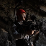 A man with a filming camera.