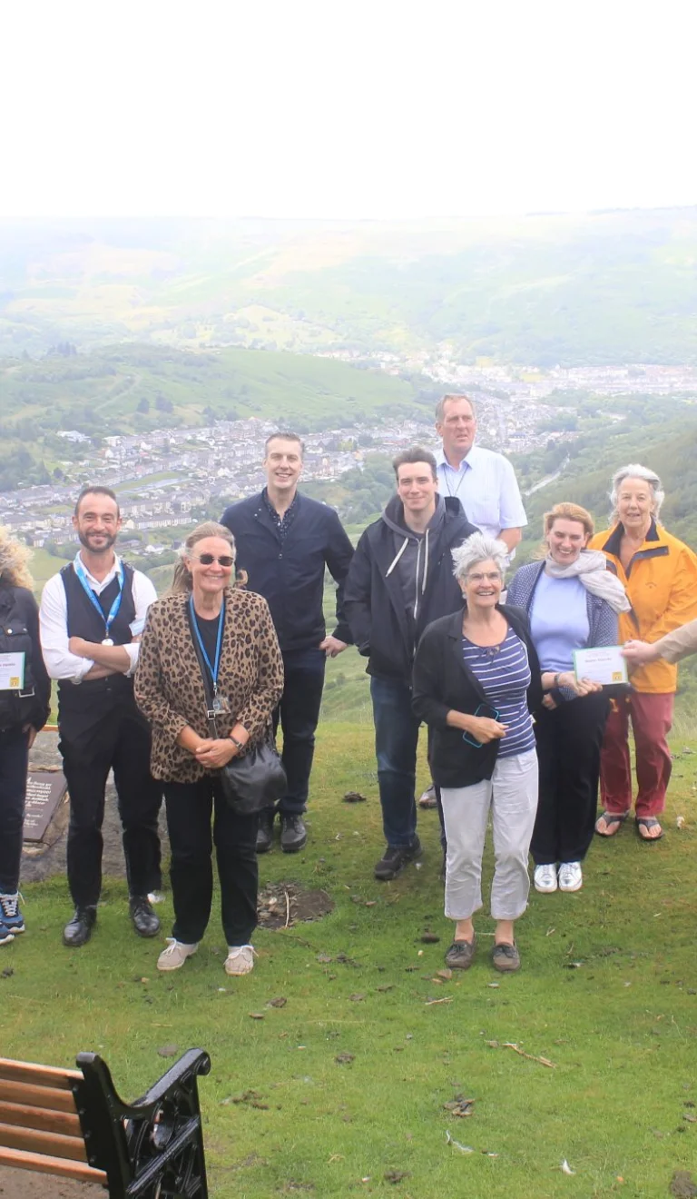 A group of people standing on a mountain on a tour of the valleys.