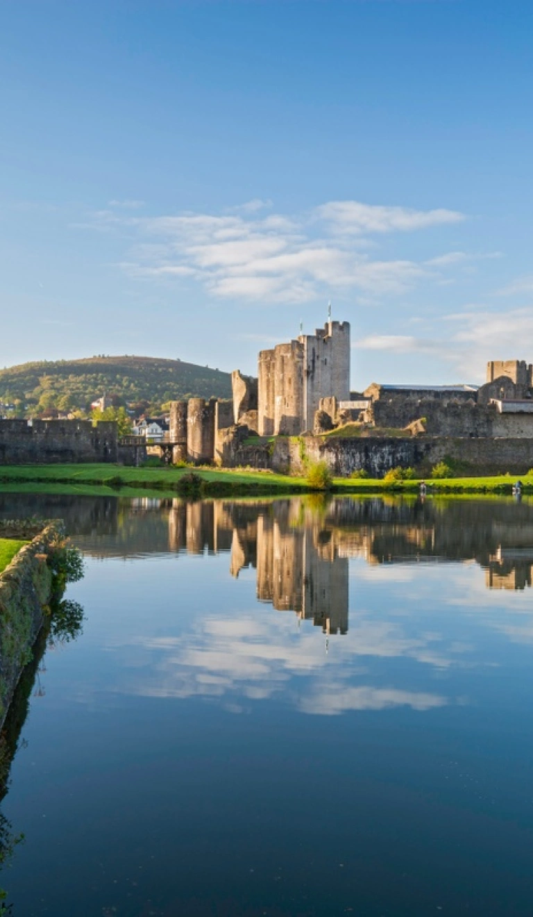 Castle overlooking a moat and greenery