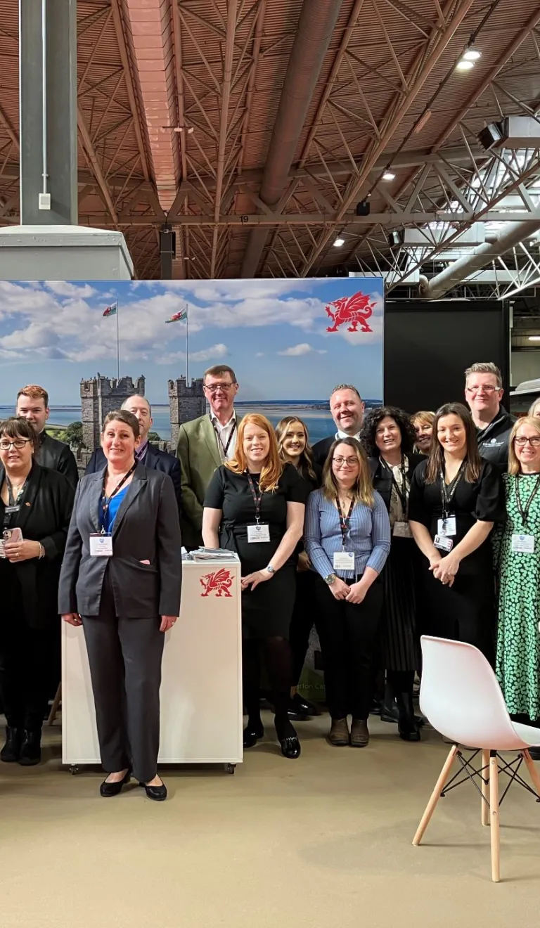 Group of people at a trade show smiling at the camera.