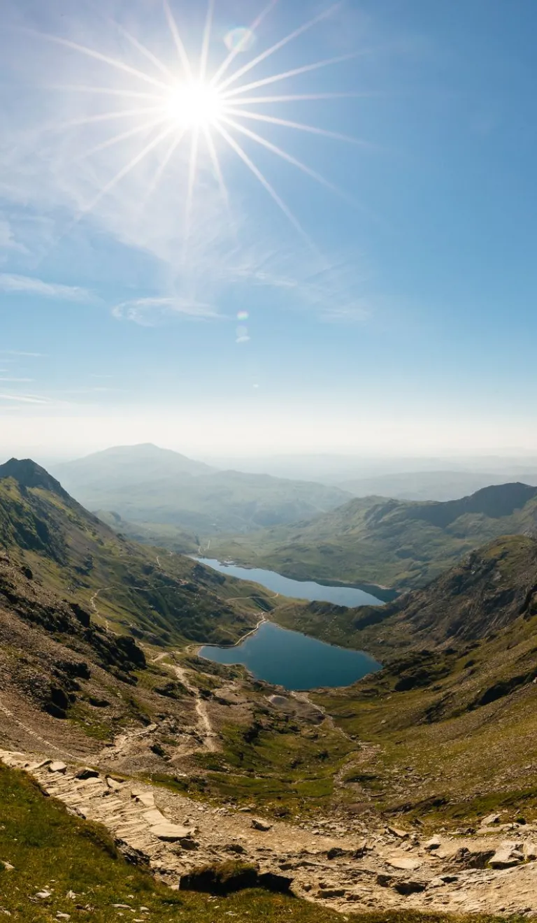 A mountain pass with views of lakes between them.