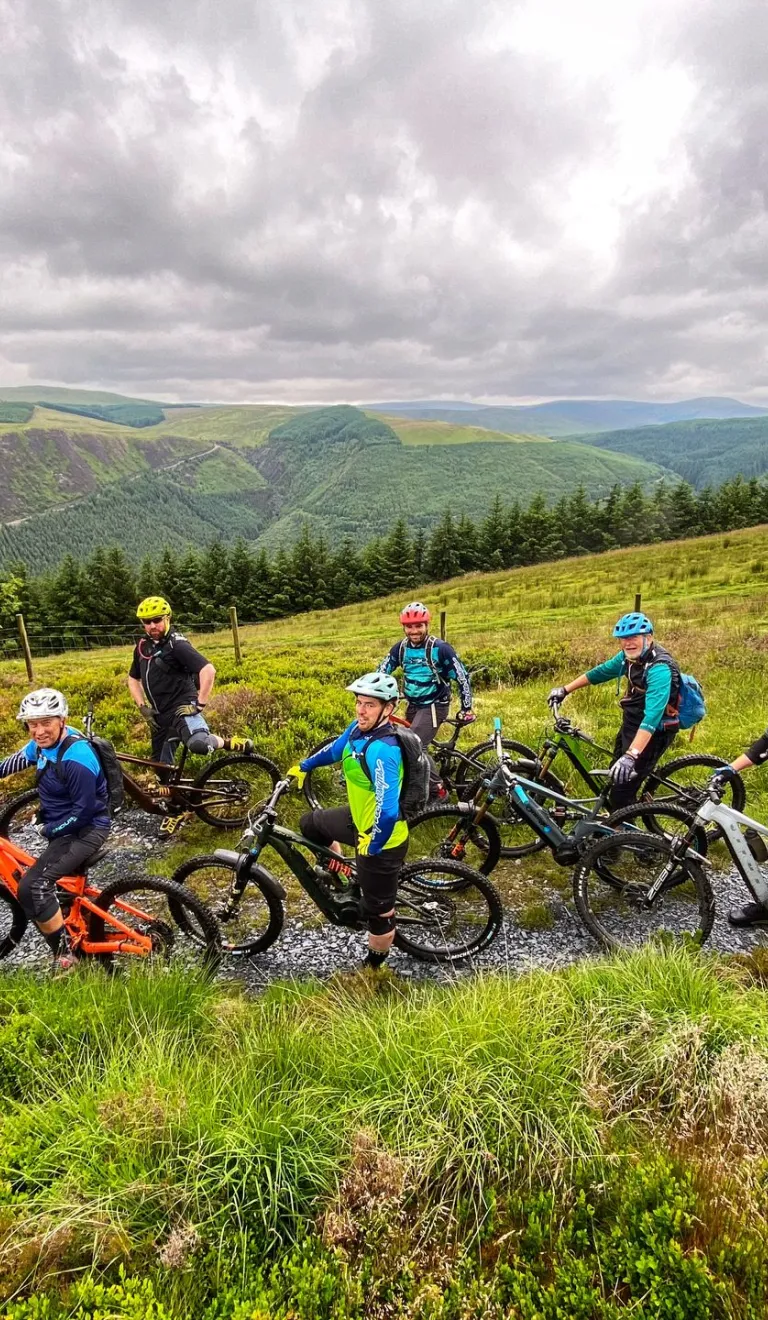 Group of cyclists on eBikes with mountain views beyond
