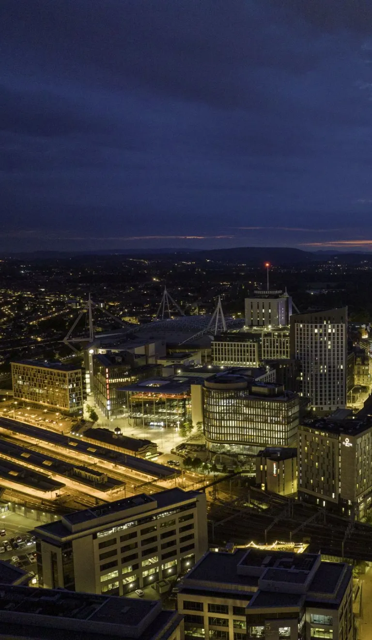 Aerial shot of a city all lit up at night.