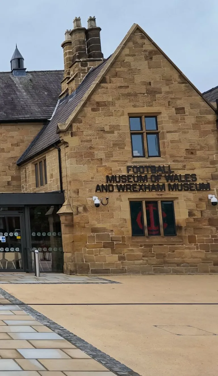 Frontage of a refurbished museum adorned with balloons on the doorway.